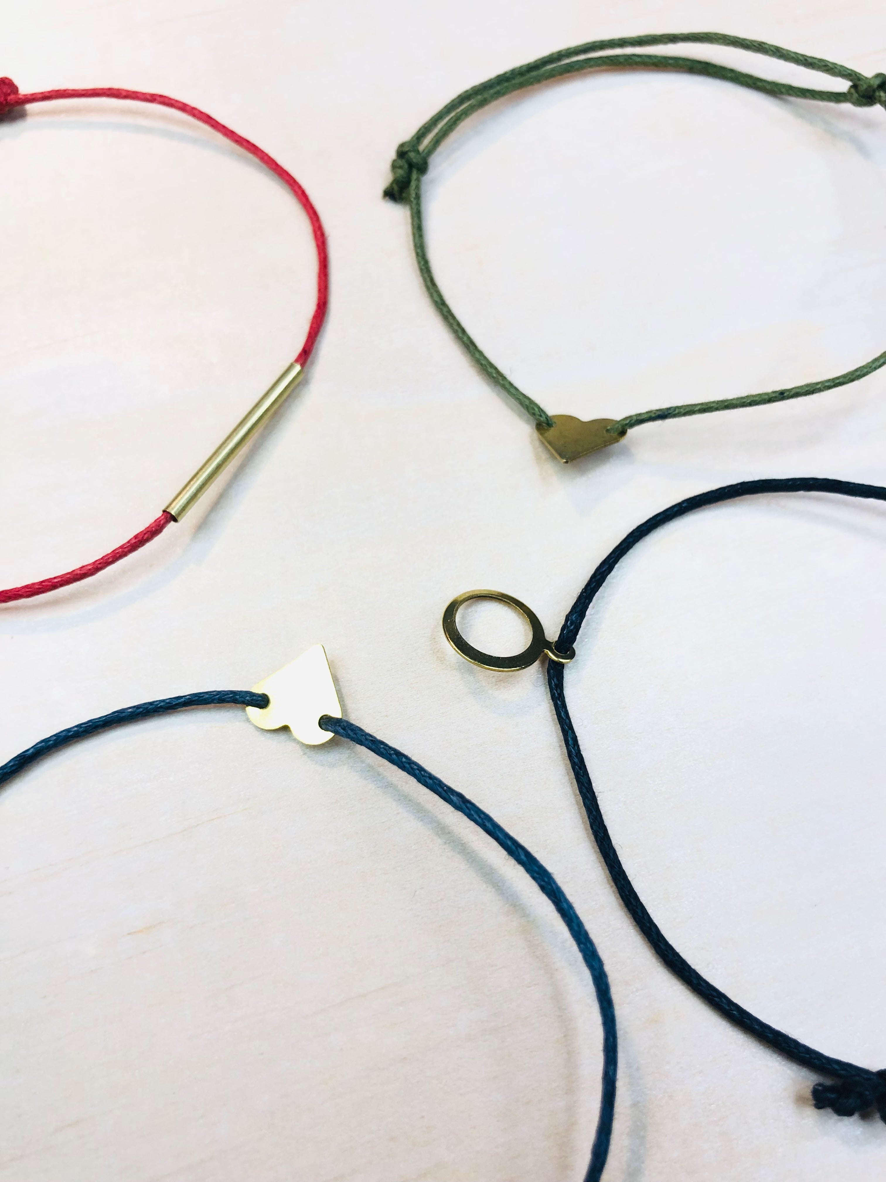 Friendship bracelet with brass charm