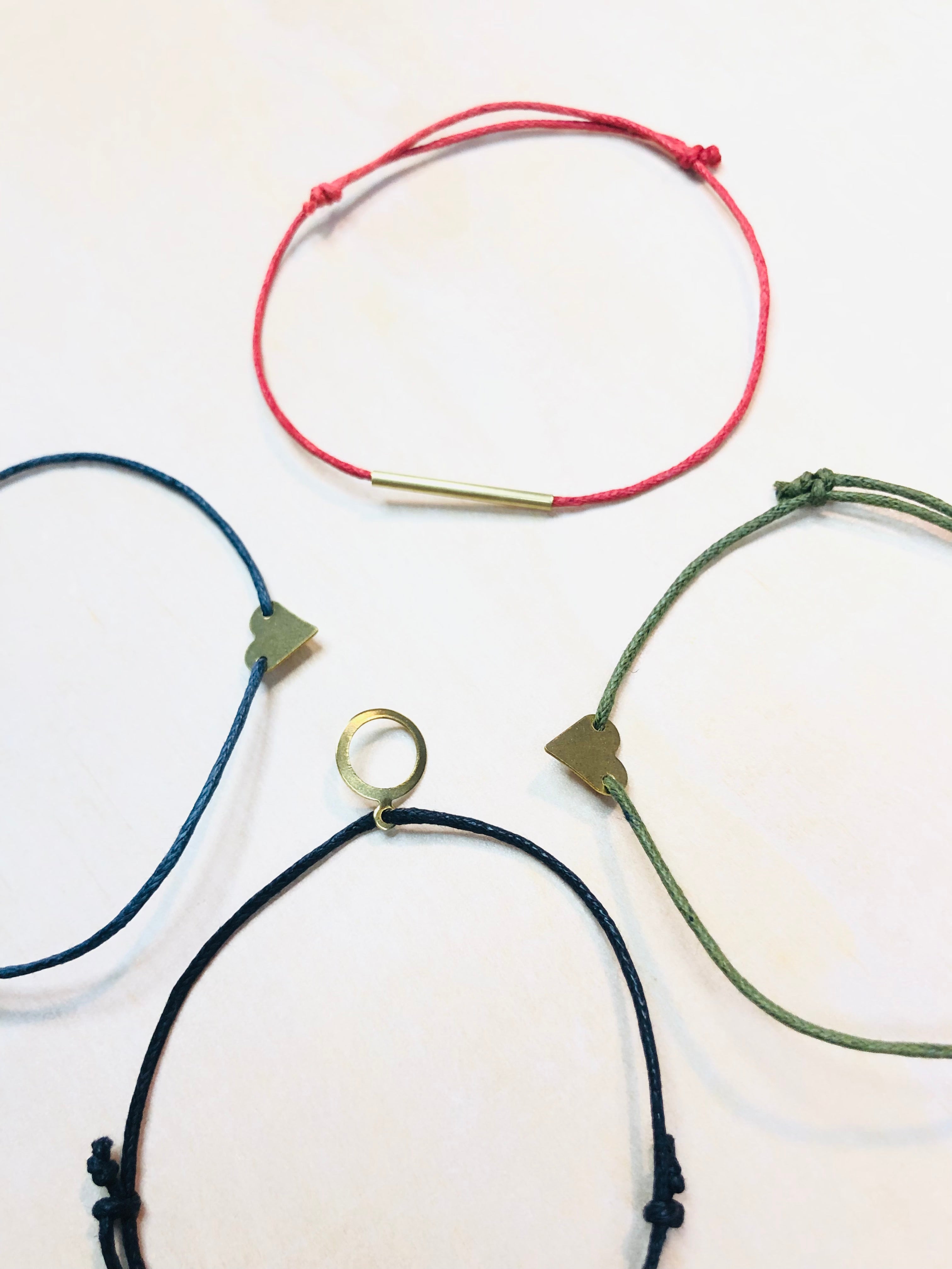 Friendship bracelet with brass charm